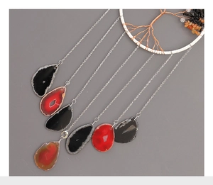 Detail of tree of life wind chime featuring agate slices and colorful crystal stones