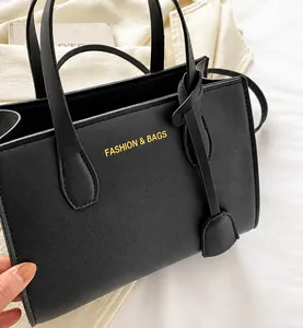 Detail view of a black matte leather crossbody bag with Fashion & Bags text print
