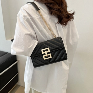 Quilted black leather crossbody bag with V-pattern and gold geometric buckle for women