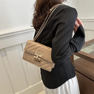 Quilted V-pattern apricot shoulder bag with gold hardware and metal chain strap