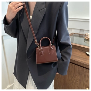 Brown-red PU leather mini crossbody bag with top handle and golden metal hardware details
