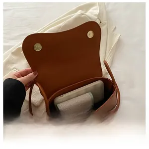 Detail view of the brown leather shoulder bag interior showing spacious capacity