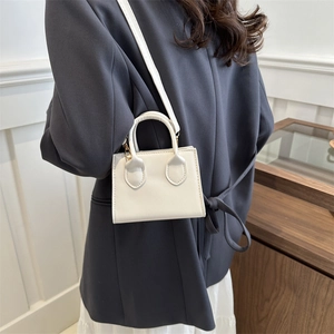 Minimalist white leather mini square handbag with top handle and detachable shoulder strap