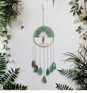 Green crystal tree of life dream catcher with natural agate slices on white wall background