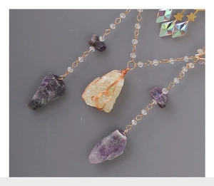 Detailed view of handmade Amethyst suncatcher with crystal stones and gold wire wrapping