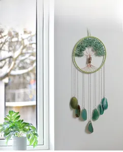 Macro detail of Tree of Life hanging ornament with green agate stones and owl charm