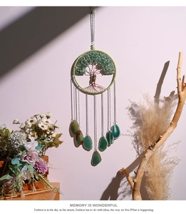 Detail of tree of life dreamcatcher with green agate slices and crystal stone weave