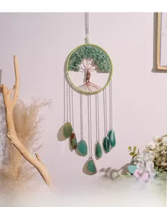 Detail of life of tree wall decor with green agate stones and hanging crystal slices