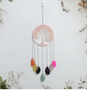 Detail of tree of life wall hanging with colorful natural agate slices and crystals
