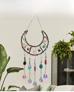 Detail of moon-shaped suncatcher with natural crystals and sparkling crystal drops