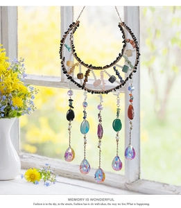 Detail of moon-shaped suncatcher with natural crystals and rainbow prisms for garden decor