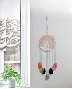 Detail of tree of life suncatcher with natural stones and seven colorful agate slices