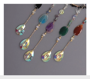 Detail of five hanging crystal suncatchers with natural crushed stones and faceted drops