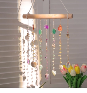 Detailed boho crystal suncatcher featuring agate slices and beads on a wooden pole