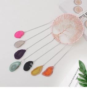 Detailed view of handmade Tree of Life dream catcher with colorful natural agate slices