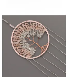 Detail of tree of life wind chime with pink crystals and silver metal chains