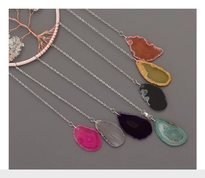Macro detail of Tree of Life dreamcatcher with colorful natural agate slices and metal chains