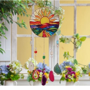 Detail of tree of life suncatcher with natural colorful agate slices on window frame