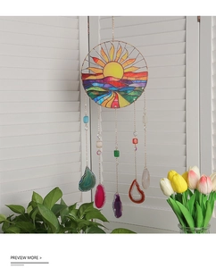Detail of sun catcher featuring stained glass scenery and vibrant natural agate slices