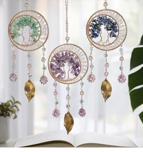 Detailed view of three handmade Tree of Life crystal pendants with colorful natural stones