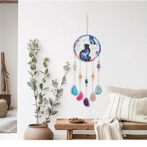 Detail of bohemian suncatcher with acrylic black cat motif and colorful agate slices