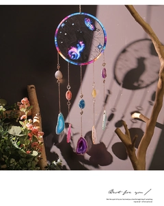 Detail view of cat suncatcher with colorful natural agate slices and artistic shadow effects