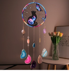 Detail of suncatcher with cat and butterfly design featuring colorful natural agate slices