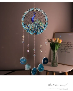 Detailed view of the peacock suncatcher with blue agate slices and rose gold metal chains