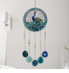 Detail of peacock glass suncatcher featuring blue agate slices and golden chains decoration