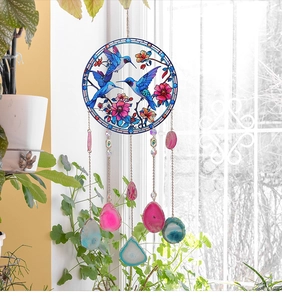 Detailed hummingbird suncatcher with vibrant agate slices hanging in natural sunlight
