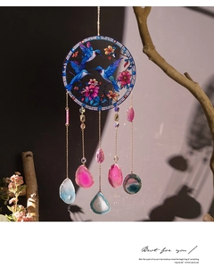 Detail of hummingbird acrylic suncatcher with colorful natural agate slices hanging on branch