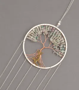 Detail of tree of life dreamcatcher with natural stones, metal deer and white pearls