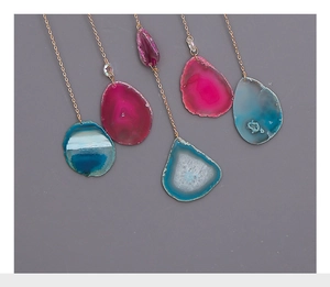 Detail of five assorted natural agate slice pendants with golden link chains
