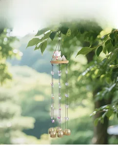 Detail of creative lucky cat wind chime with purple butterfly beads and six brass bells