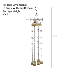 Japanese lucky cat wind chime with brass bells and iridescent butterfly charms on wood base