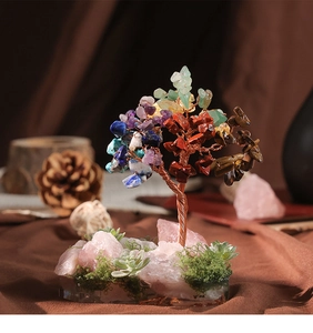 Detailed close-up of handmade tree of life with colorful crystals and rose quartz base