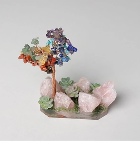 Macro shot of colorful crystal gem tree with natural pink quartz base and wire trunk