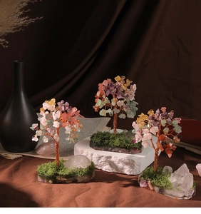 Detailed view of handmade natural crystal money trees with copper wire and gemstone leaves