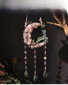 Detail of dreamlike moon crescent wall decor with pink crystals and star pendant