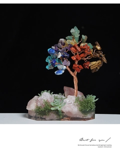 Macro detail of a handmade chakra crystal money tree with rose quartz base and copper wire