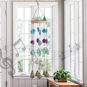 Bohemian agate wind chime with pink crystals and copper bells hanging by a window