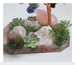Detail of crystal money tree base with pink quartz stones and moss in resin
