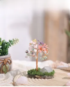 Detail of colorful crystal gemstone tree with copper wire and moss base decoration