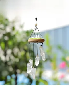 Detail of natural white crystal prism wind chime with five stones and wooden base
