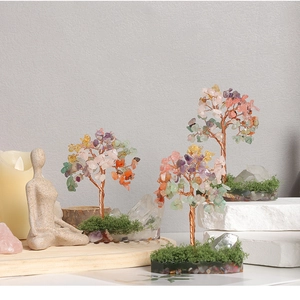 Detailed macro view of three handcrafted crystal money trees on decorative stone bases