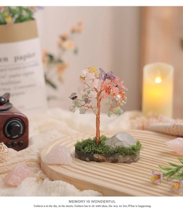 Close-up of handmade multi-color crystal tree with copper wire on wood tray