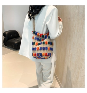 Detail of colorful patchwork knit plush tote bag with vibrant multi-color textured squares