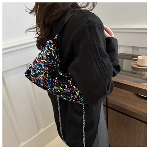Close-up of stylish sequin shoulder bag with silver chain and black leather strap