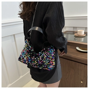 Detail of colorful sequin crossbody bag with black leather handle and metal chain strap