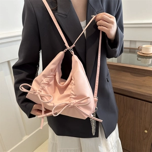 Chic pink ruffled drawstring backpack with bow accents and silver chain strap